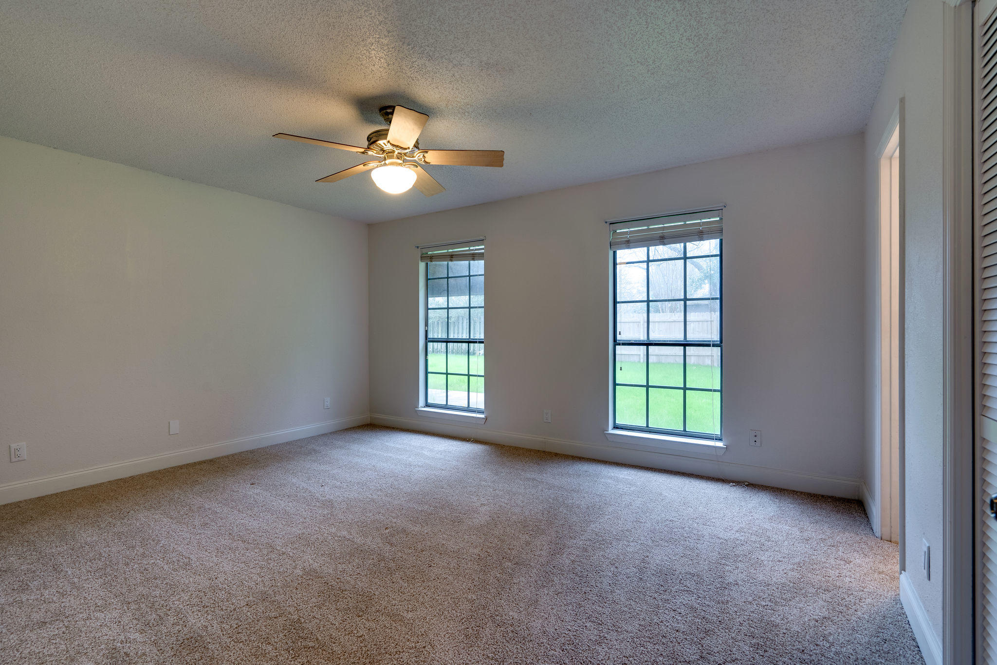 409 Juniper Street Destin, FL 32541 - Photo 23 of 32 an empty room with ceiling fan and window