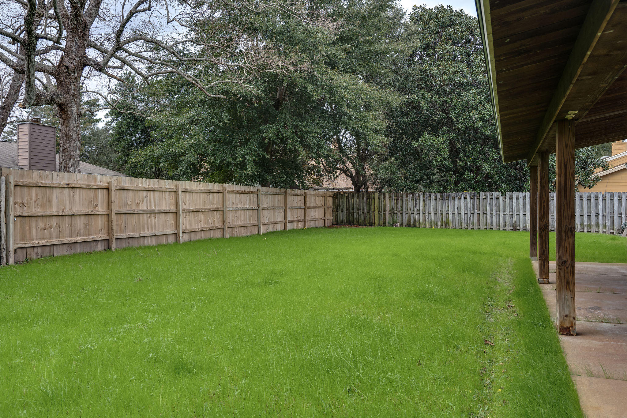 409 Juniper Street Destin, FL 32541 - Photo 27 of 32 a view of a yard with wooden fence