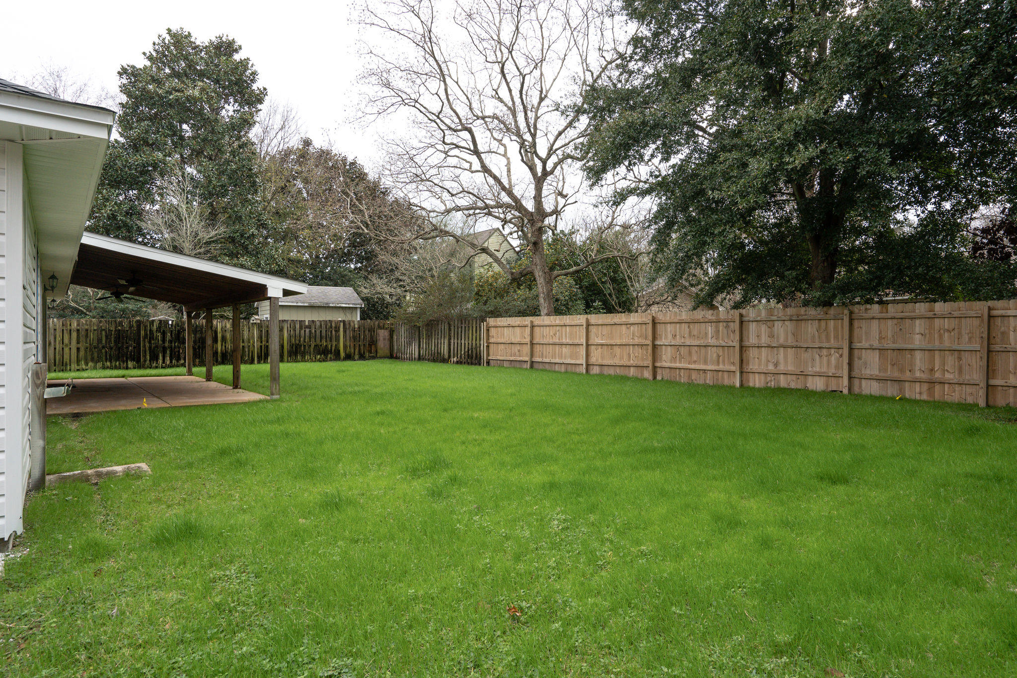 409 Juniper Street Destin, FL 32541 - Photo 28 of 32 a view of a house with backyard and a garden