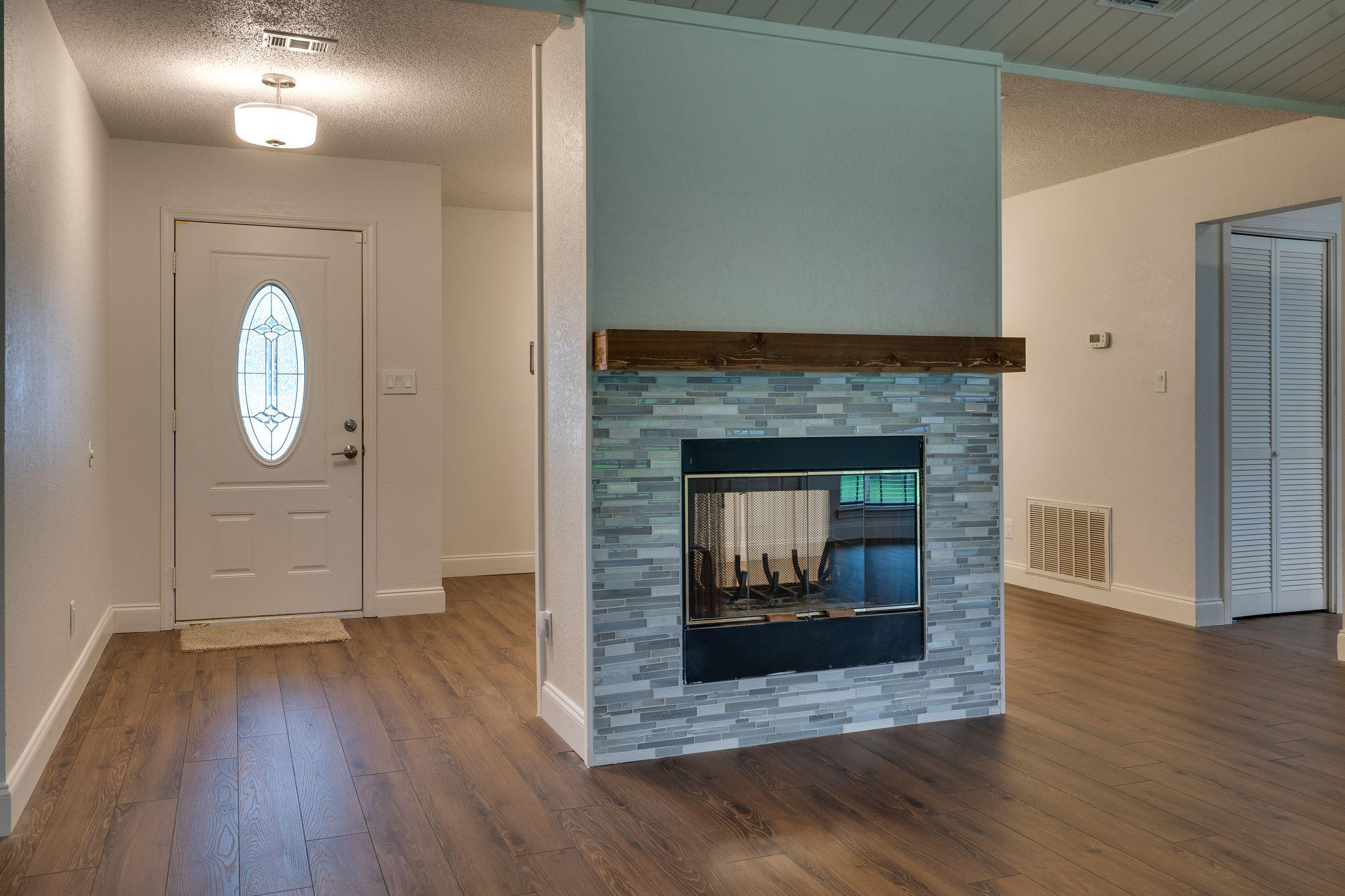 409 Juniper Street Destin, FL 32541 - Photo 4 of 32 a view of a livingroom with wooden floor and a fireplace
