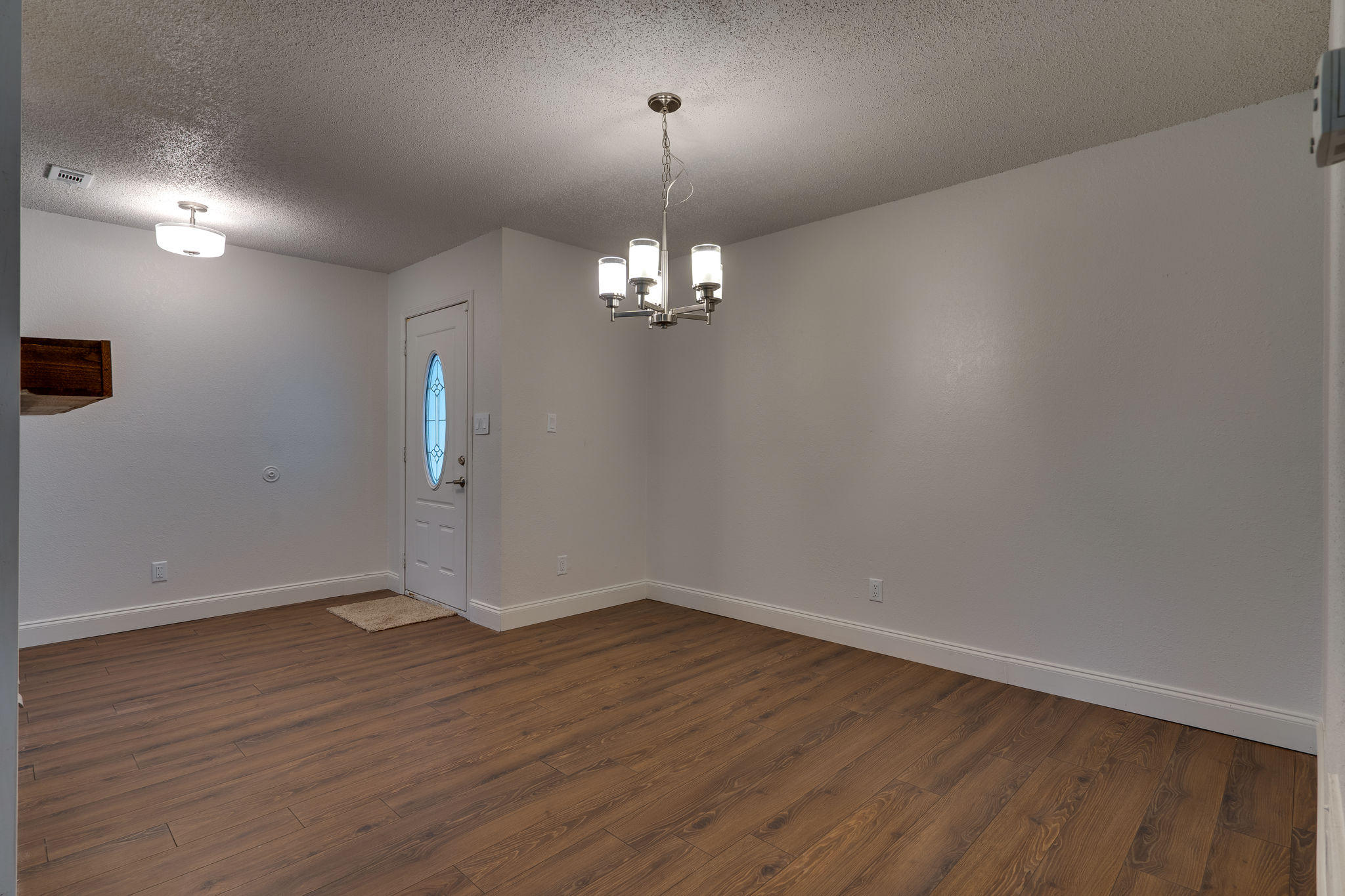 409 Juniper Street Destin, FL 32541 - Photo 6 of 32 an empty room with wooden floor and windows