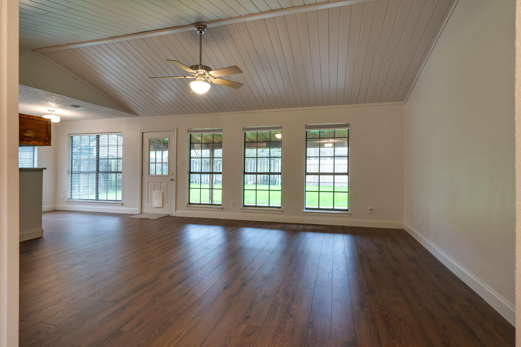 409 Juniper Street Destin, FL 32541 - Photo 7 of 32 a view of an empty room with wooden floor and a window