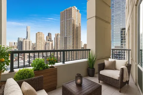 a balcony with furniture and a potted plant