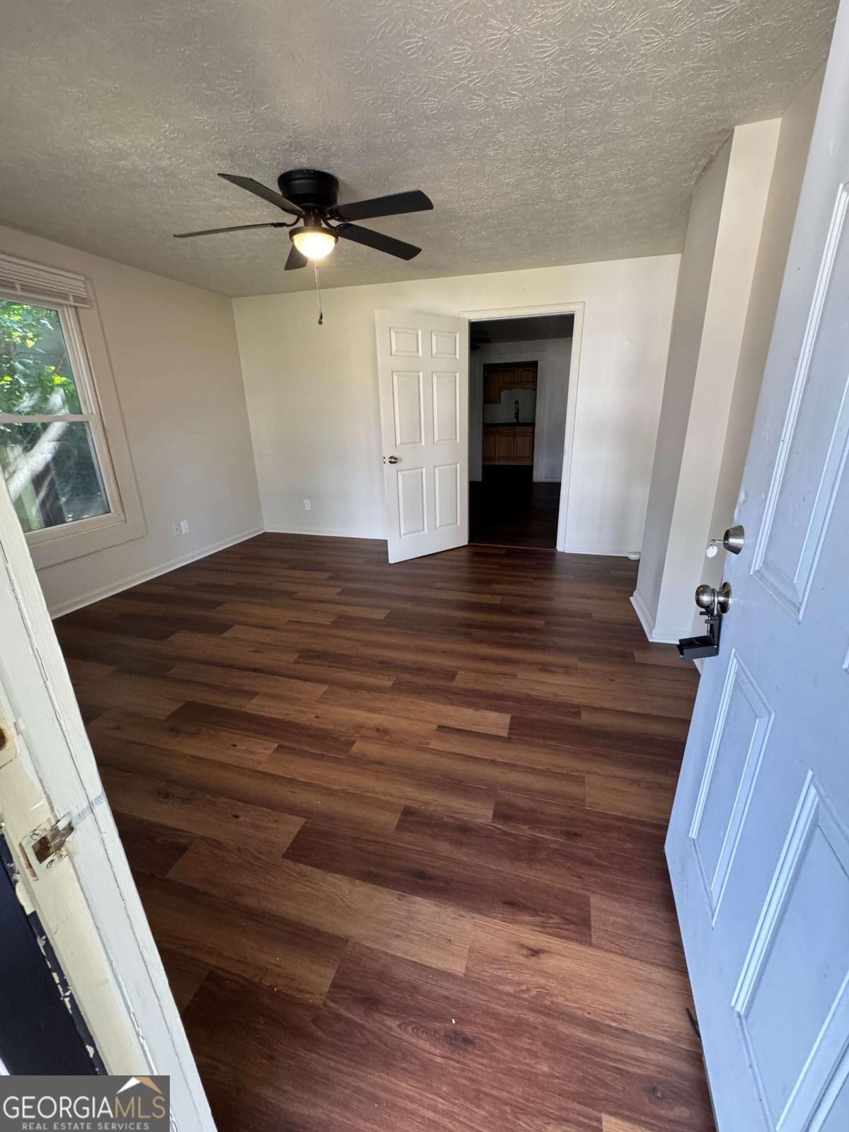 110 Summit Street Southeast Gainesville, GA 30501 - Photo 11 of 18 a view of an empty room with wooden floor and a window