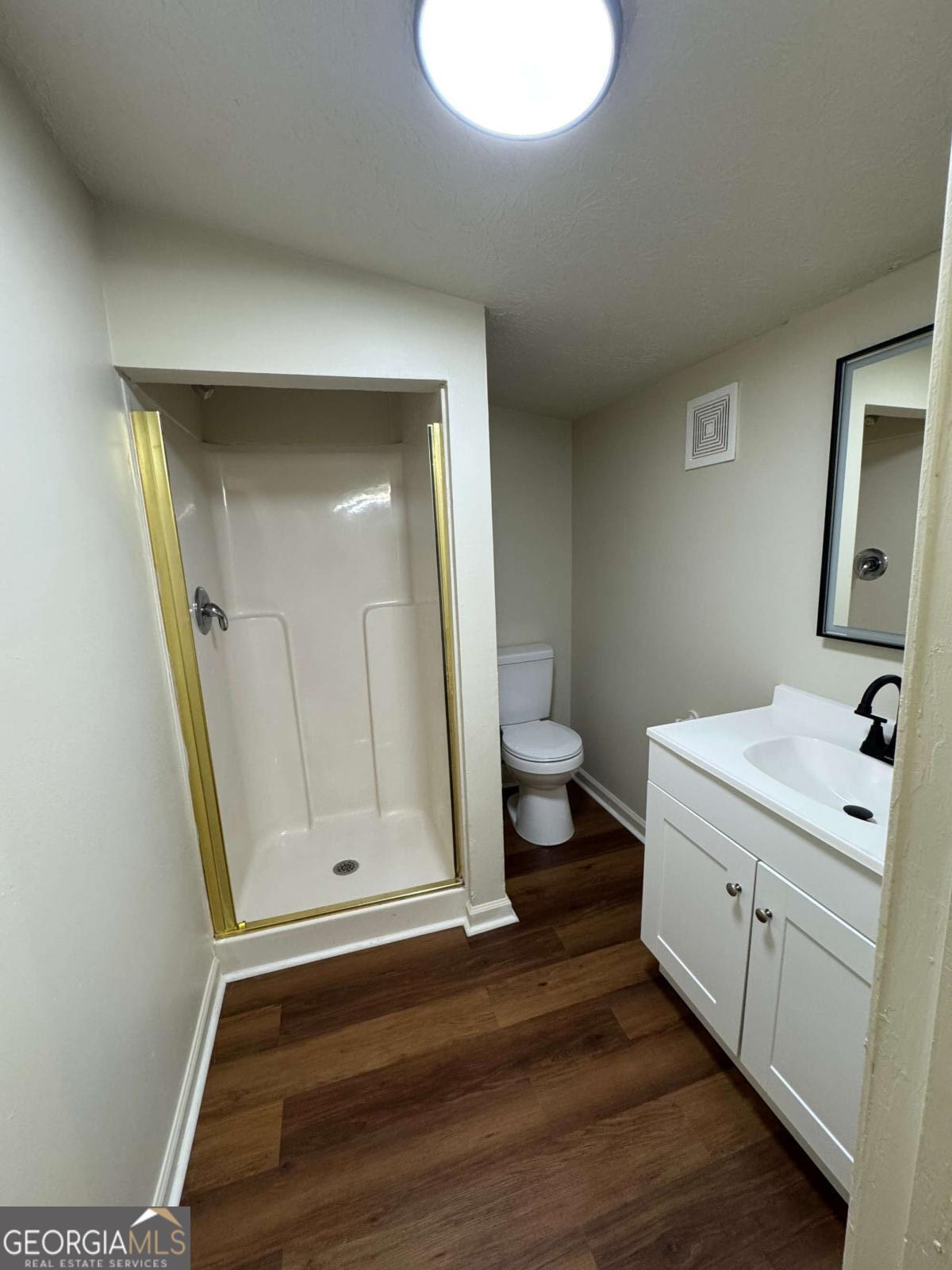 110 Summit Street Southeast Gainesville, GA 30501 - Photo 12 of 18 a bathroom with a sink a toilet and mirror