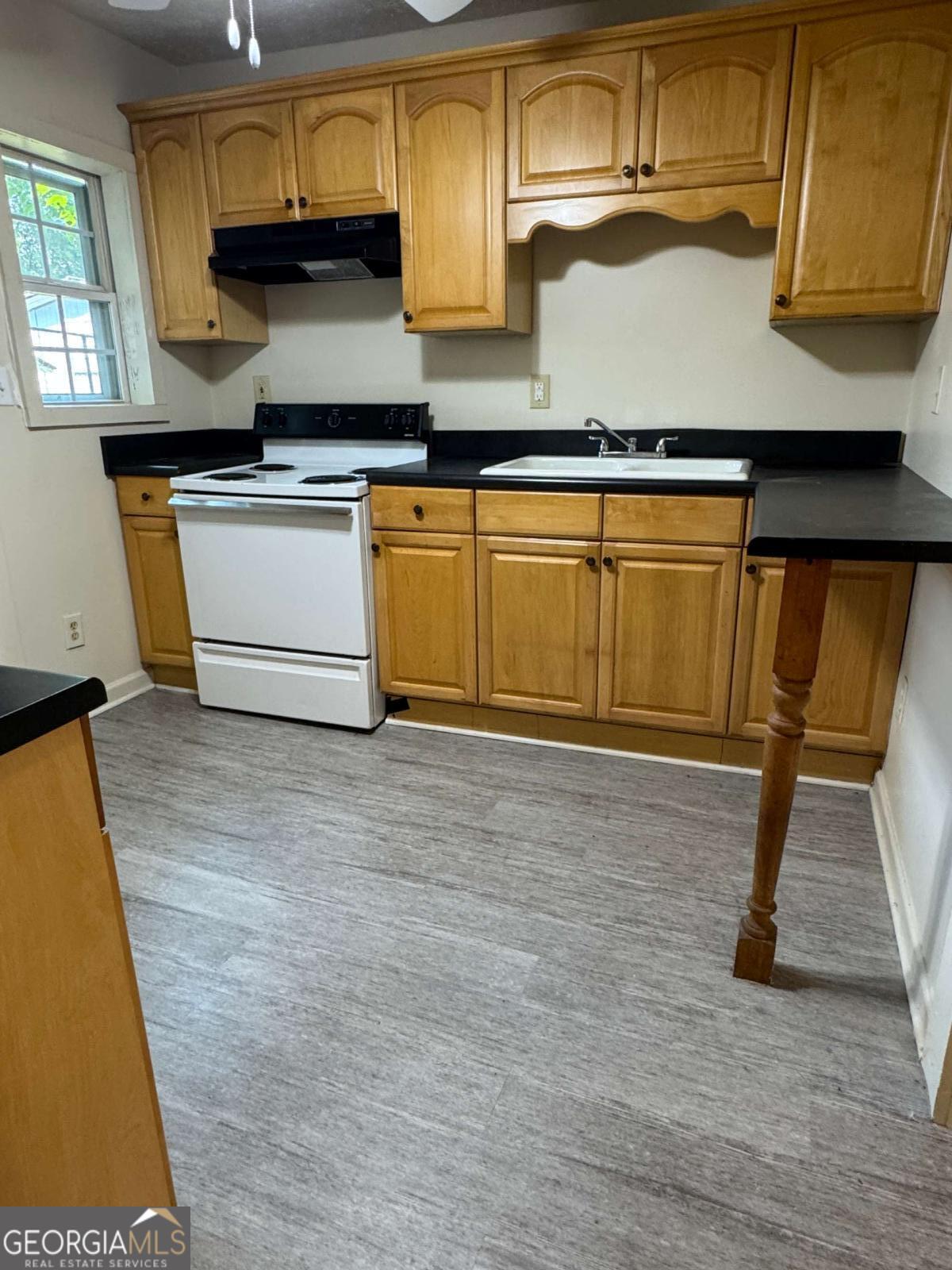 110 Summit Street Southeast Gainesville, GA 30501 - Photo 5 of 18 a kitchen with stainless steel appliances granite countertop a stove a sink and a microwave