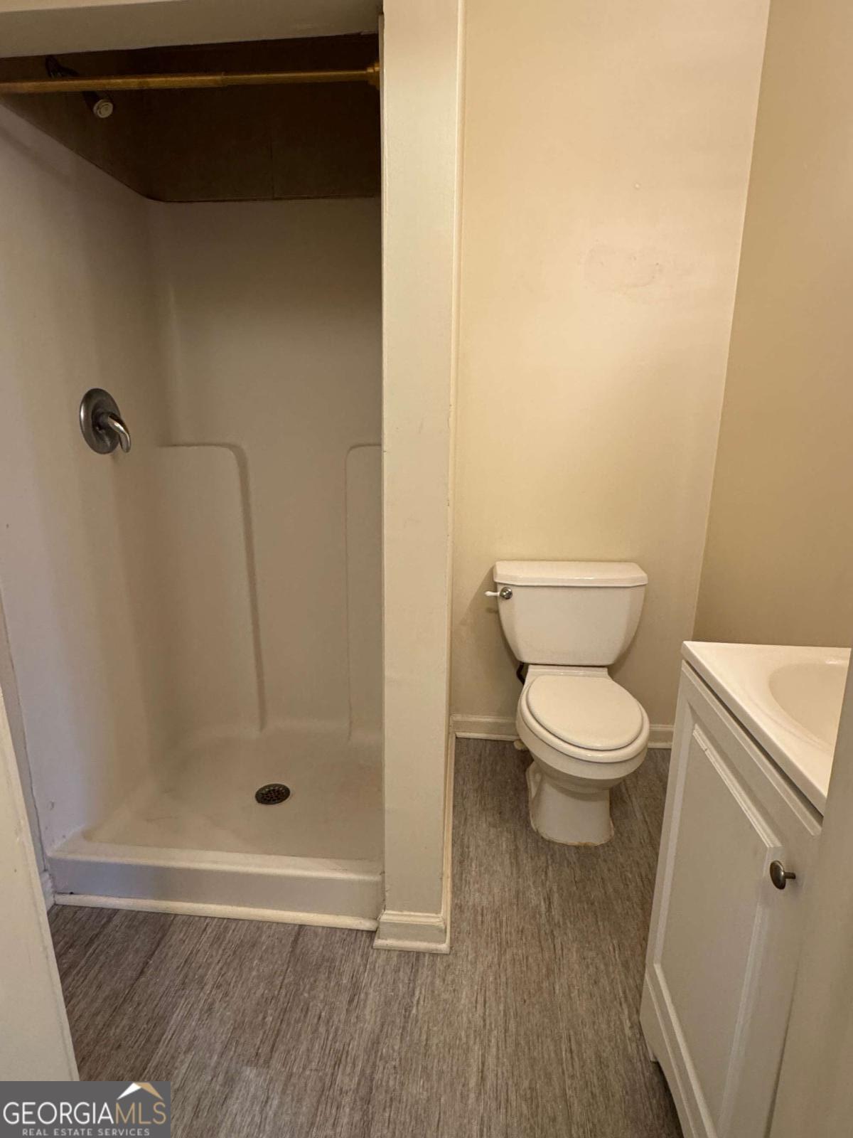 110 Summit Street Southeast Gainesville, GA 30501 - Photo 7 of 18 a white toilet sitting next to a bathroom sink
