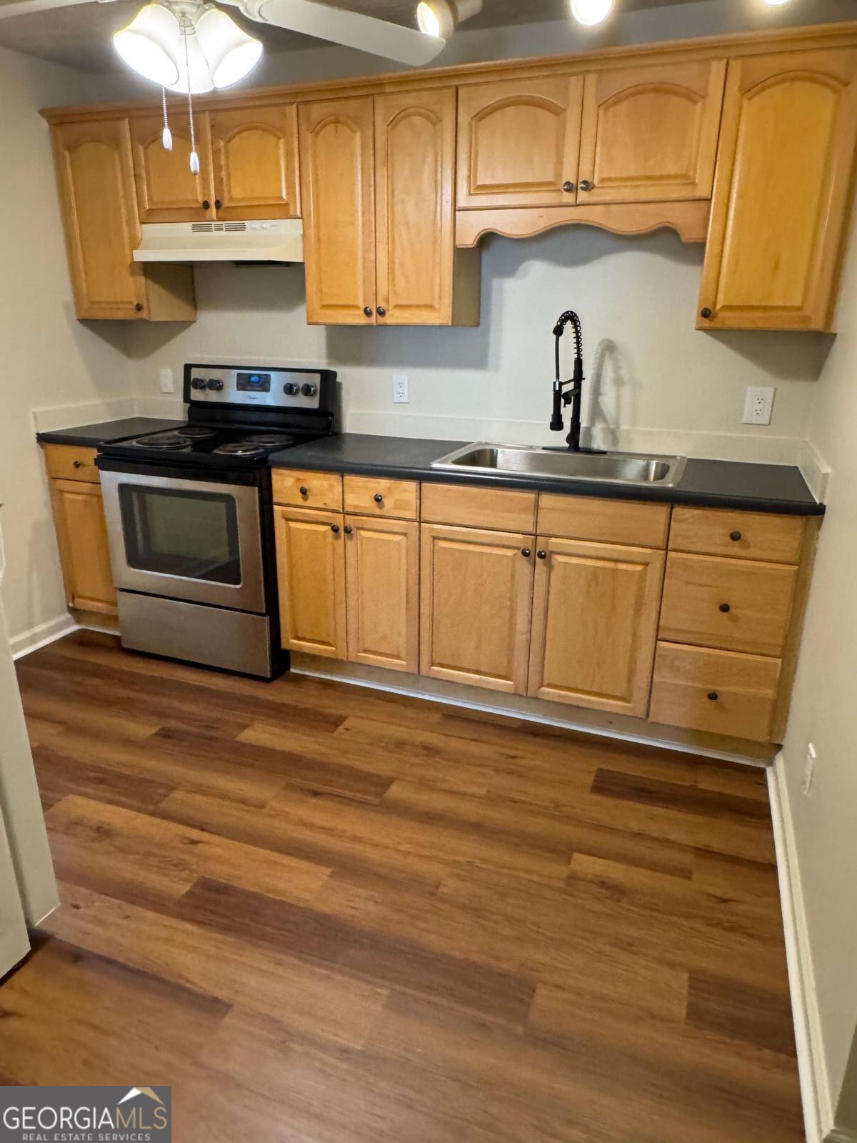 110 Summit Street Southeast Gainesville, GA 30501 - Photo 10 of 18 a kitchen with stainless steel appliances granite countertop a sink a stove and cabinets