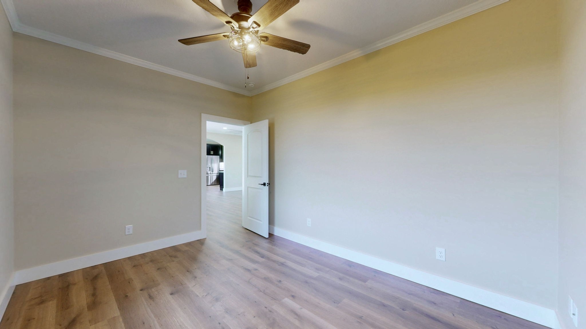 865 Alman Cemetery Road Paris, TN 38242 - Photo 27 of 41 a view of an empty room with wooden floor and a ceiling fan