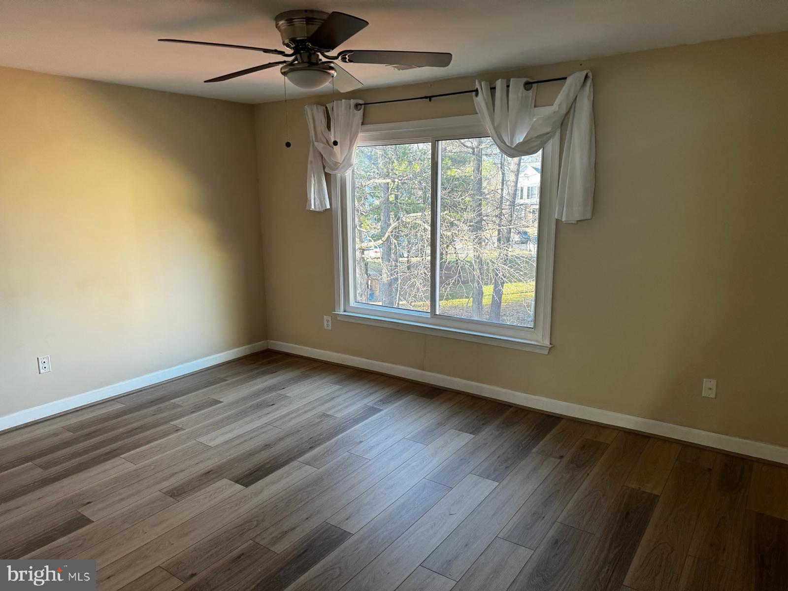21131 Crocus Terrace Ashburn, VA 20147 - Photo 14 of 37 a view of an empty room with a window and wooden floor