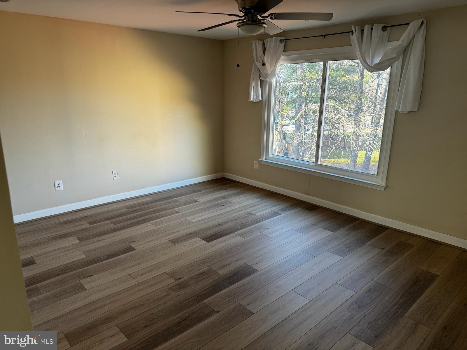 21131 Crocus Terrace Ashburn, VA 20147 - Photo 15 of 37 a view of an empty room with wooden floor and a window