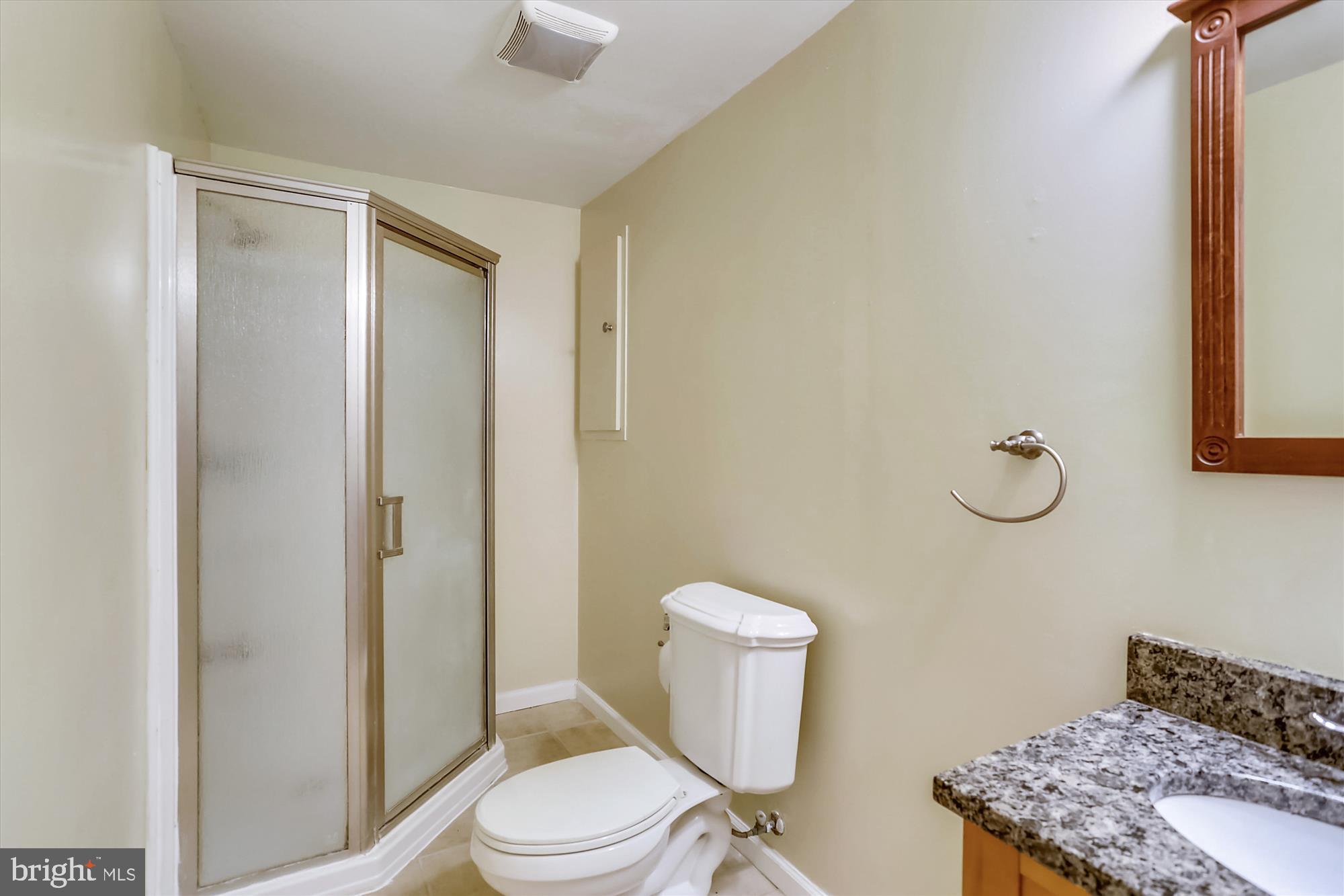 21131 Crocus Terrace Ashburn, VA 20147 - Photo 2 of 37 a bathroom with a granite countertop toilet a sink and a mirror
