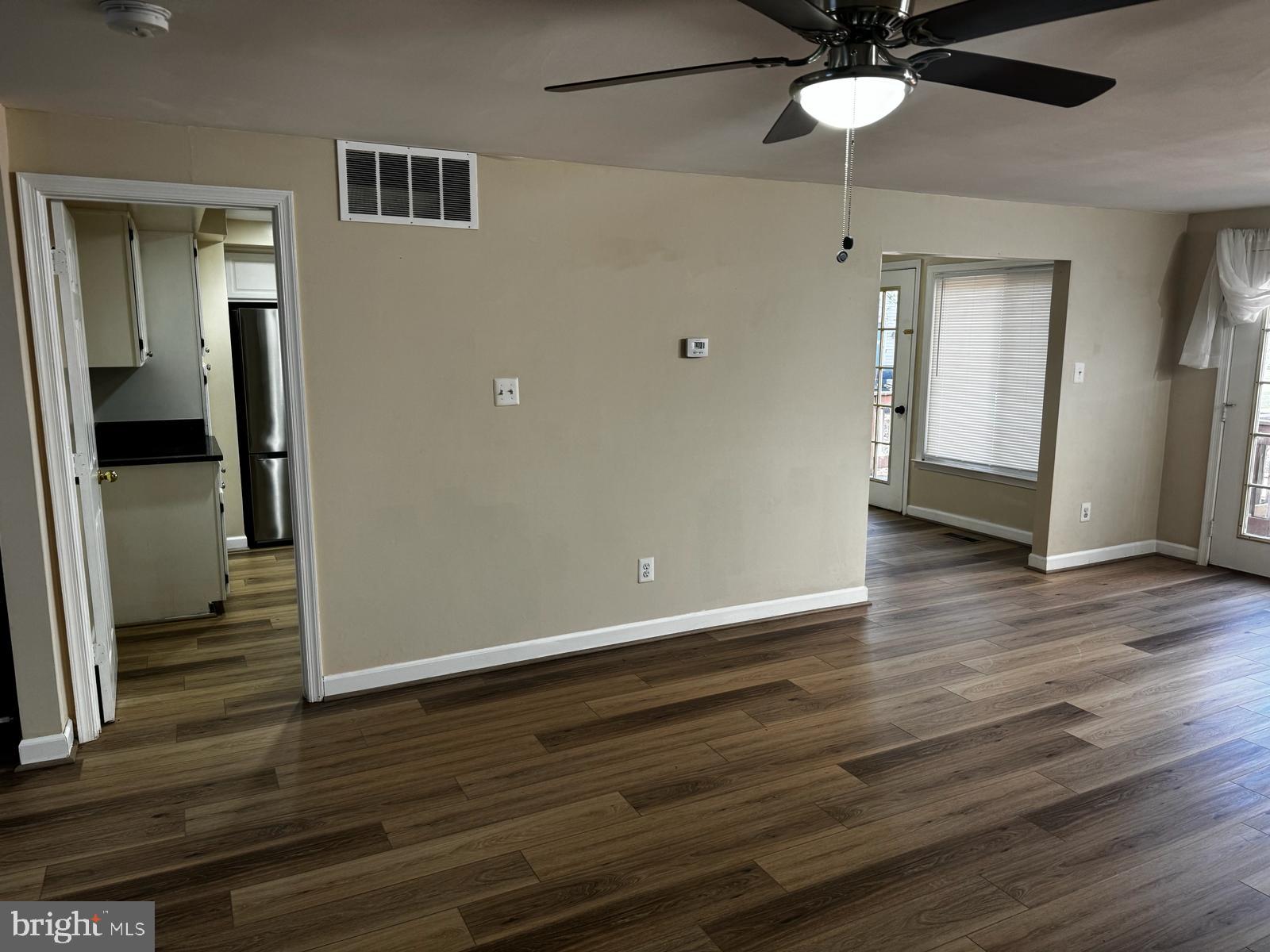 21131 Crocus Terrace Ashburn, VA 20147 - Photo 24 of 37 an empty room with wooden floor cabinet and a ceiling fan