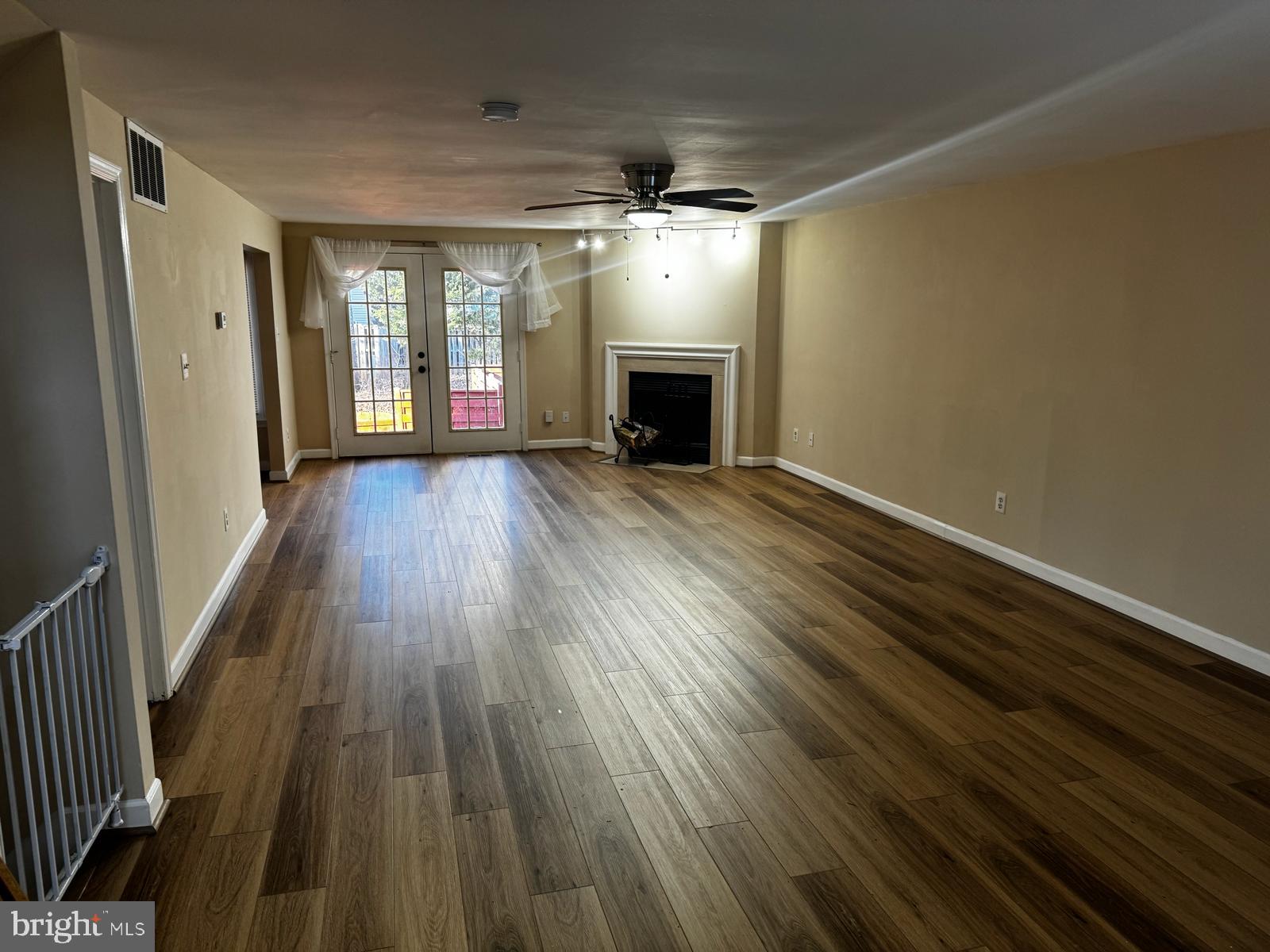 21131 Crocus Terrace Ashburn, VA 20147 - Photo 33 of 37 wooden floor in an empty room with a fireplace