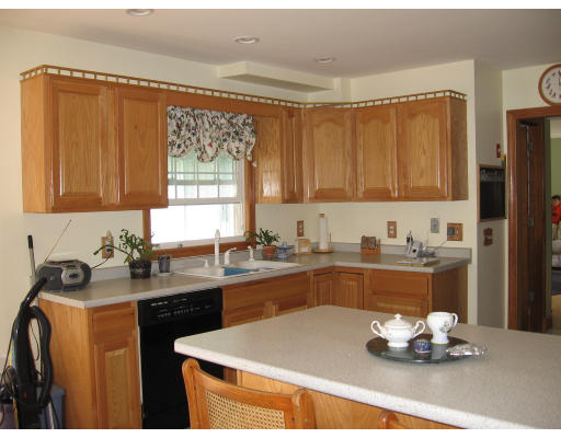 22 Bennett Road Rochester, MA 02770 - Photo 4 of 4 a kitchen with a sink stove and cabinets