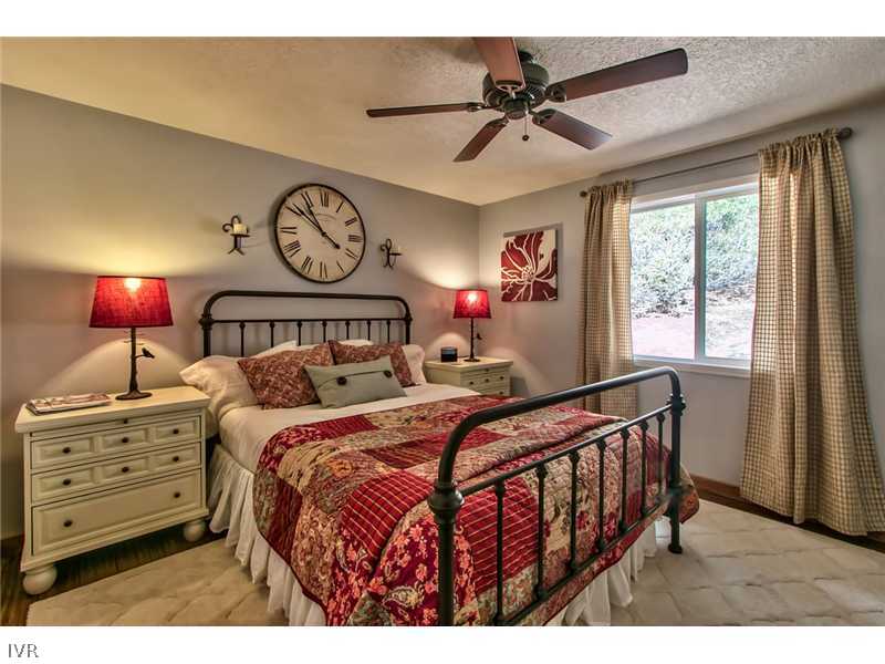 844 Jeffrey Street Incline Village, NV 89451 - Photo 9 of 17 a bedroom with a bed a chandelier and a window
