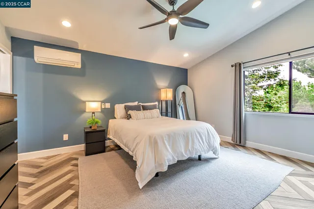 a bedroom with a large bed and a large window