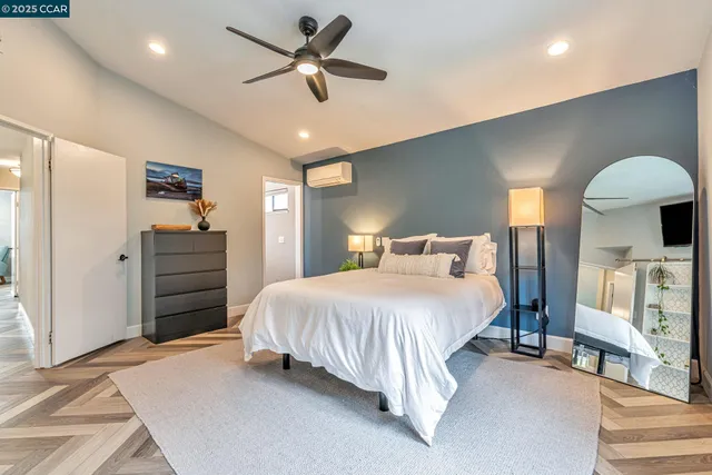 a spacious bedroom with a bed and a ceiling fan