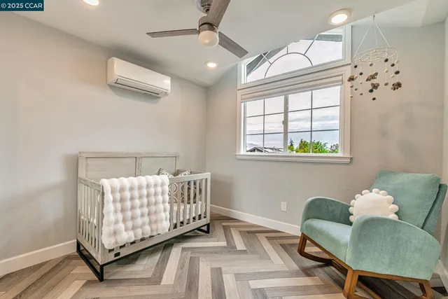 a bedroom with a bed and a potted plant