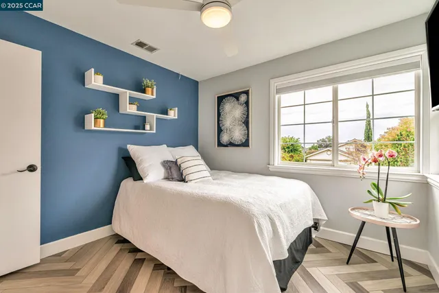 a bedroom with a large bed and a flat screen tv