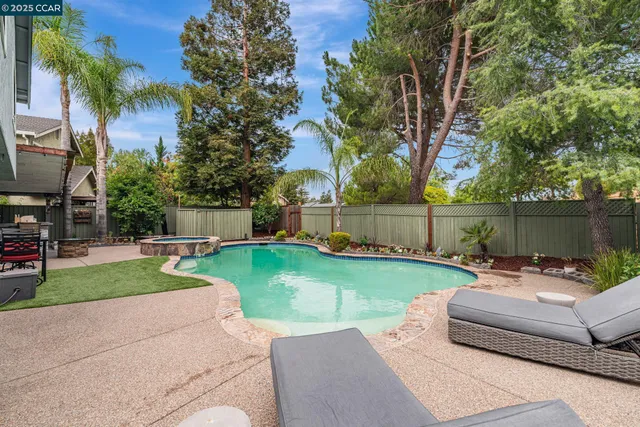 a view of a house with a yard patio and swimming pool