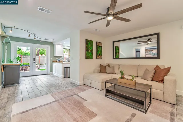 a living room with furniture and ceiling windows