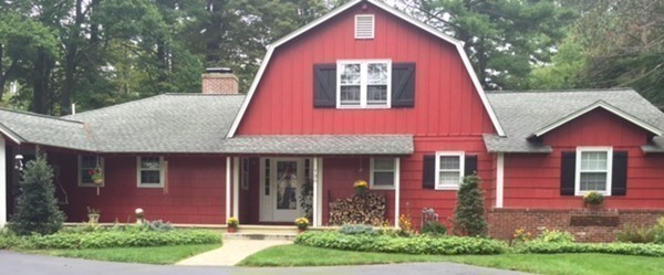 130 Hidden Road Andover, MA 01810 - Photo 1 of 27 a view of a brick house with a yard plants and large tree