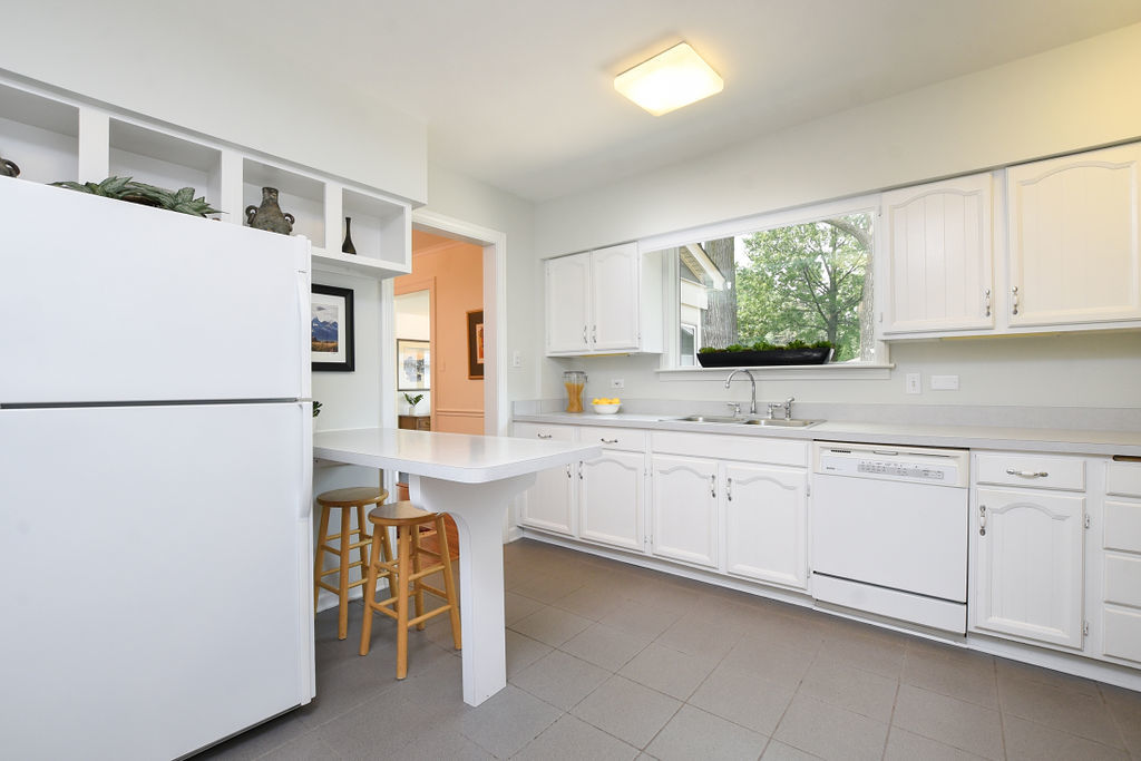 4620 Wolf Road Western Springs, IL 60558 - Photo 6 of 20 a kitchen with granite countertop white cabinets and white appliances