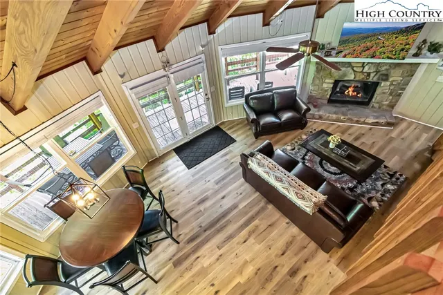 a living room with furniture a fireplace and a table