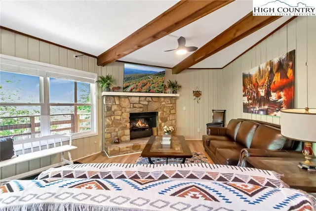 a kitchen with a table chairs microwave and stove top oven