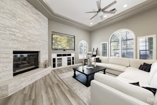 a living room with furniture a fireplace and a flat screen tv