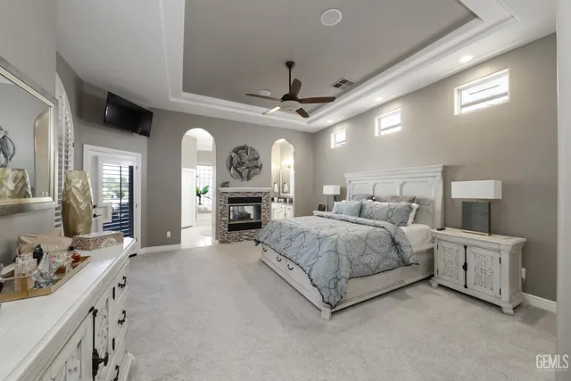 a spacious bedroom with a large bed and a large window