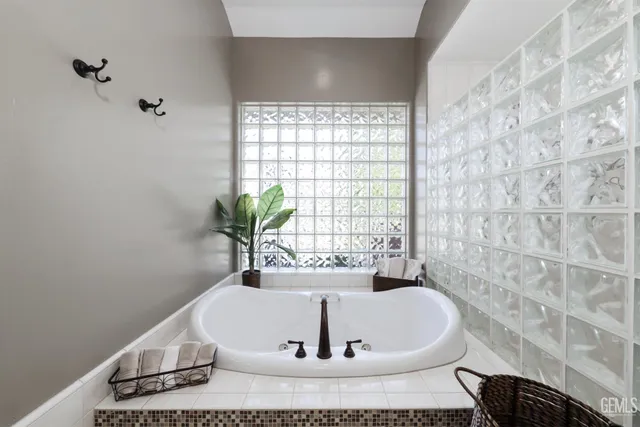 a spacious bedroom with a bed a ceiling fan and a couch