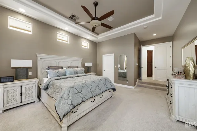 a kitchen with stainless steel appliances sink a stove and white cabinets