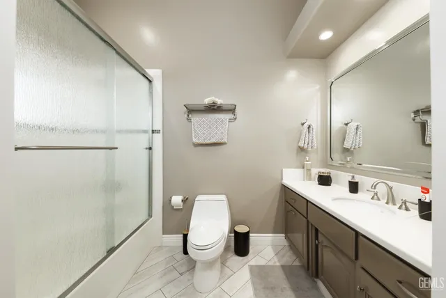 a bathroom with a toilet tub and shower