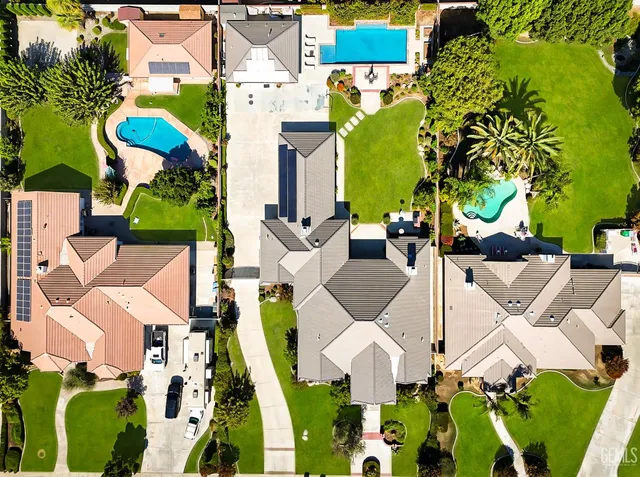 an aerial view of a house with garden space and street view