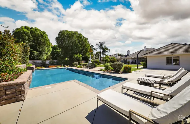 a view of a swimming pool with a lounge chair