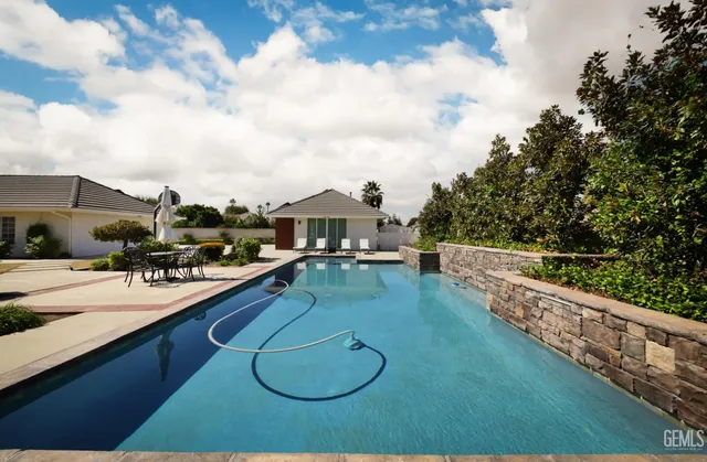 a view of house with yard and entertaining space
