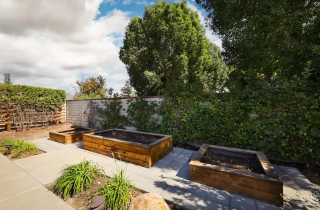 a view of a house with a big yard and a large trees