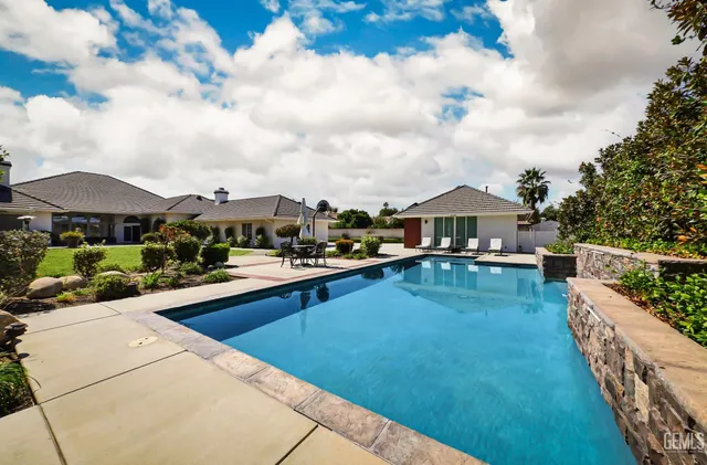 an aerial view of a house with a garden and trees