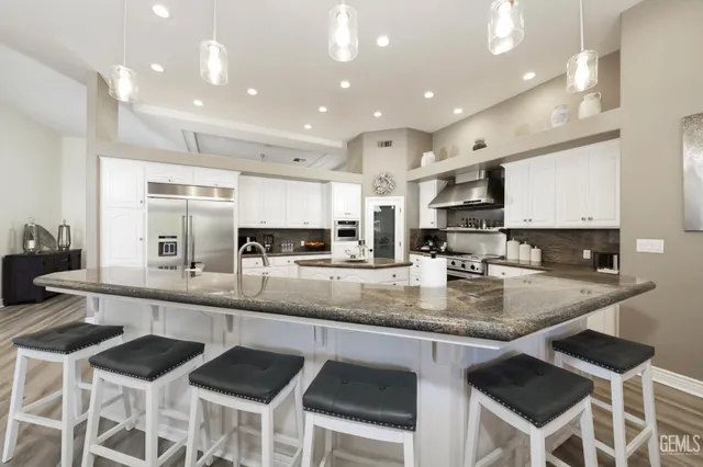 a large kitchen with granite countertop lots of counter space and window
