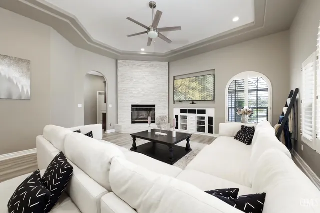 a living room with furniture a fireplace and a chandelier