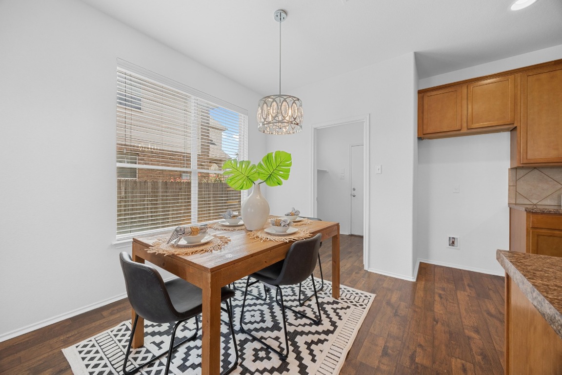 3612 Raven Caw Pass Pflugerville, TX 78660 - Photo 18 of 40 a view of a dining room with furniture window and wooden floor