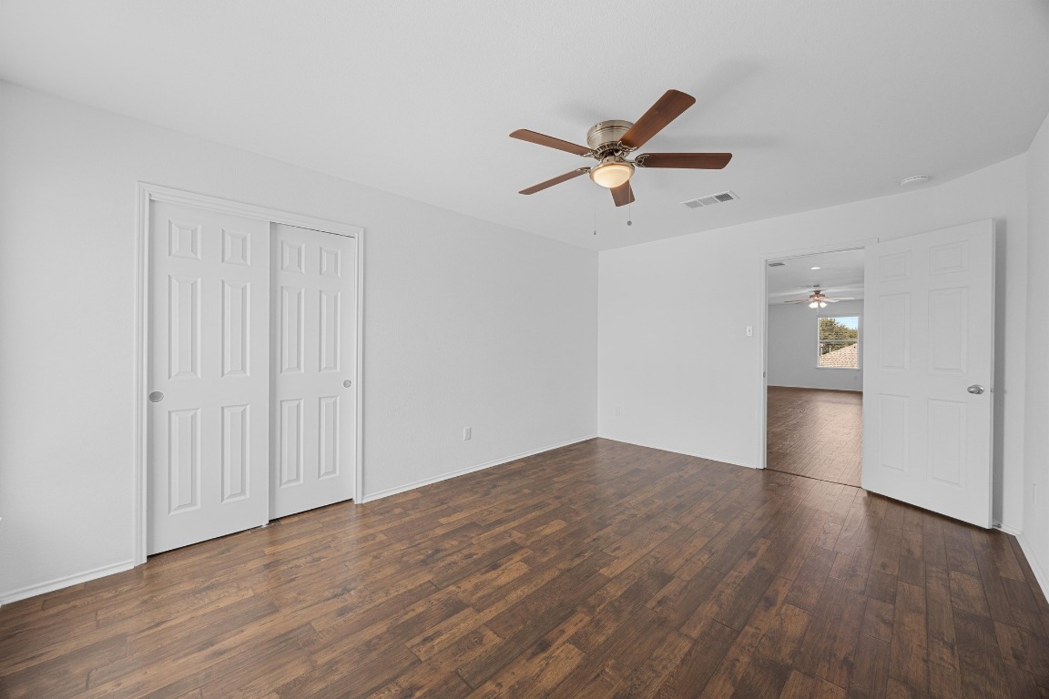 3612 Raven Caw Pass Pflugerville, TX 78660 - Photo 28 of 40 a view of empty room with wooden floor and ceiling fan