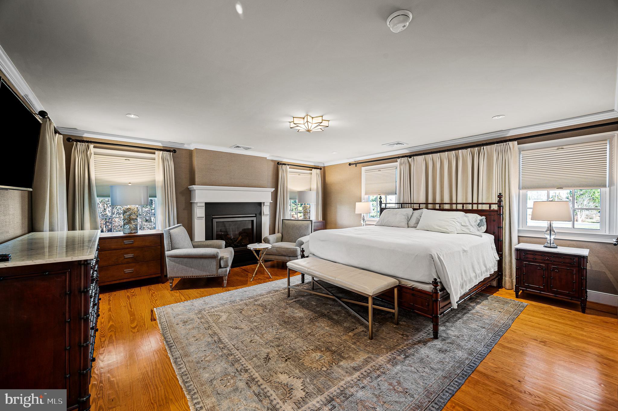 2029 East Buckshutem Road Port Norris, NJ 08349 - Photo 12 of 32 a spacious bedroom with a bed and a fireplace