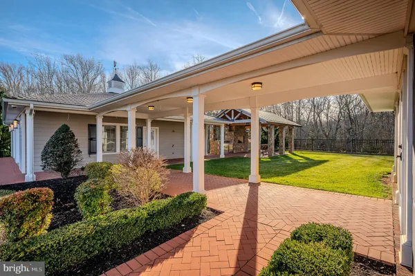 a view of a house with backyard and patio