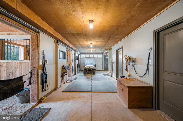 a view of a hallway with the couches and dining room view