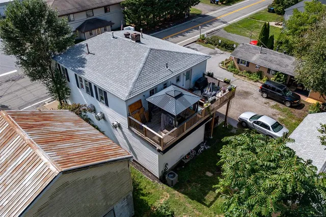 an aerial view of a house with balcony and entryway