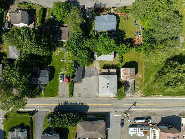 an aerial view of a house with swimming pool and garden