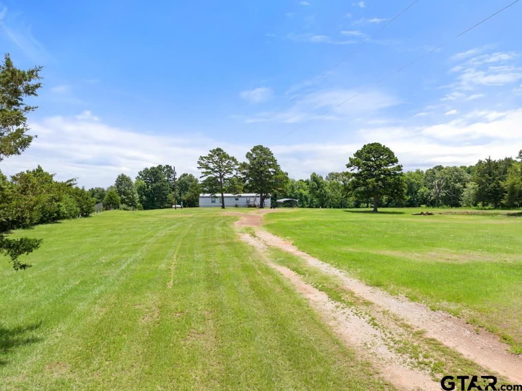 5353 County Road 385 Tyler, TX 75708 - Photo 10 of 28 a view of a green field with wooden fence